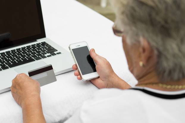 Elderly,Lady,Makes,A,Purchase,Through,The,Internet,With,A