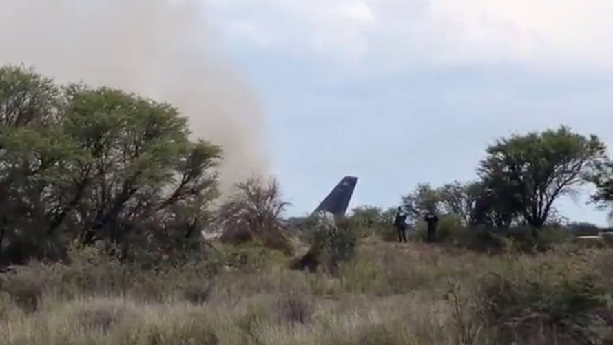 People gather near a site where an Aeromexico-operated Embraer passenger jet crashed in Mexico's northern state of Durango