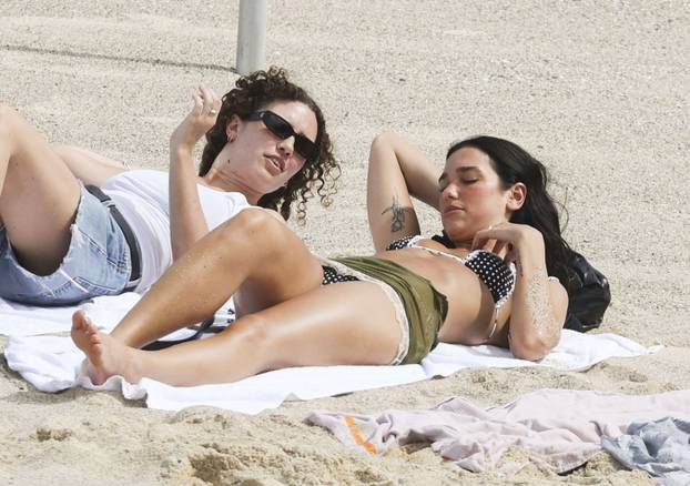 *NO DAILYMAIL ONLINE* Dua Lipa meets a Bondi Lifeguard as she checks out the sights of Sydney, visiting Tamarama beach and the Bondi to Bronte cliff walk with mates