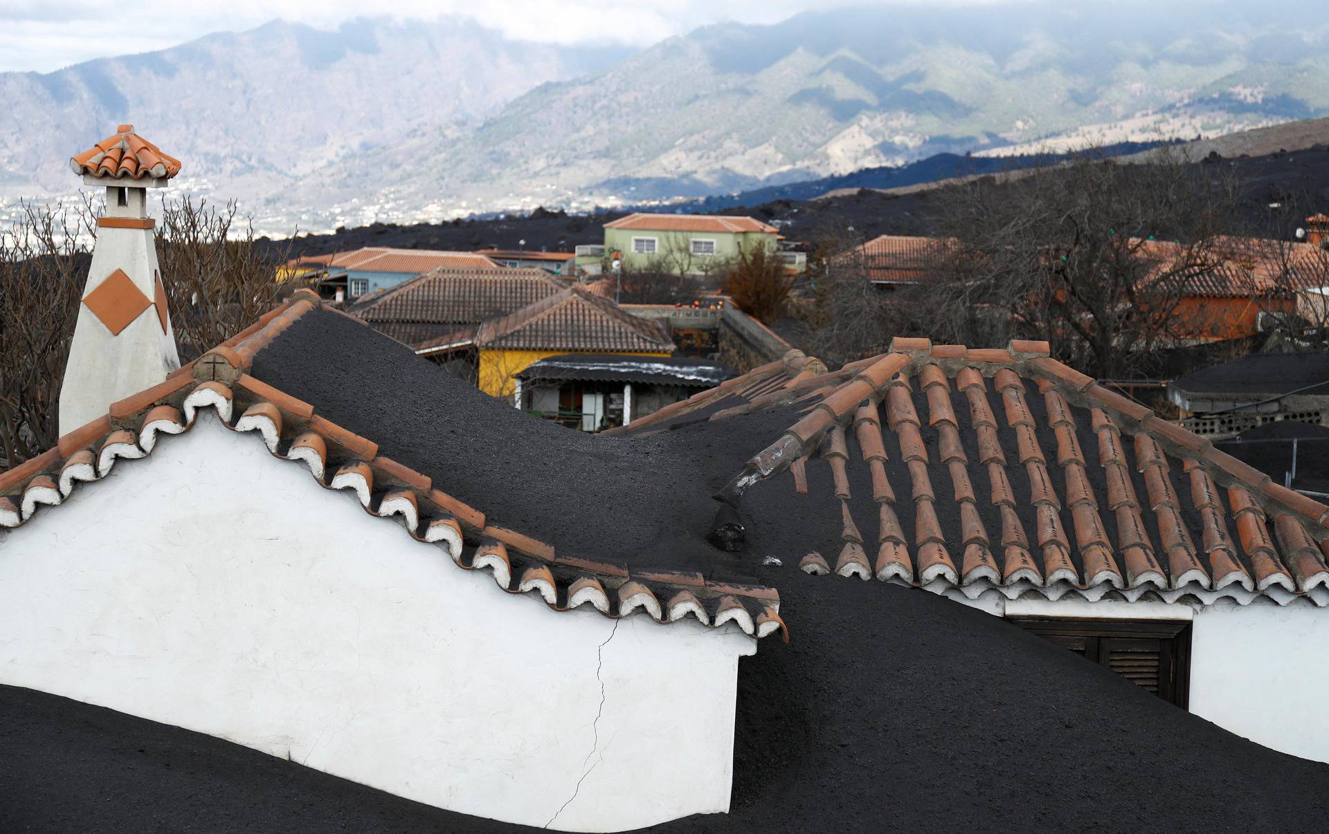 Several houses are seen buried in ash from the Cumbre Vieja volcano in Las Manchas