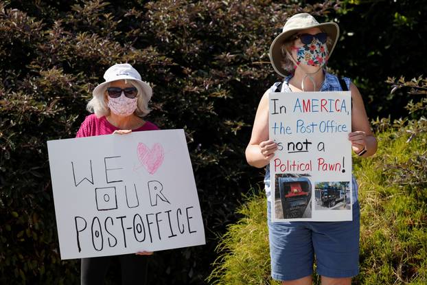 Supporters of the U.S. Postal Service protest cutbacks outside a post office in San Diego