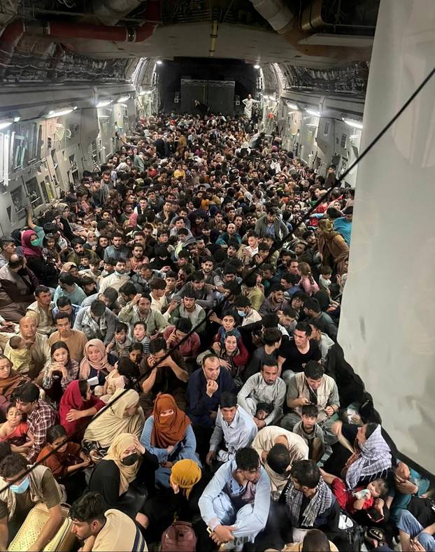Evacuees crowd the interior of a U.S. Air Force C-17 Globemaster III transport aircraft departing Kabul