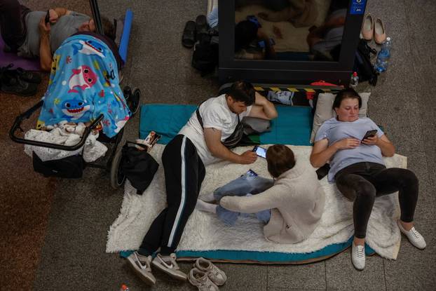 People take shelter inside a metro station during an air raid alert in Kyiv