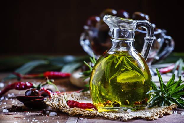 Olive oil with rosemary and spices in a glass jug