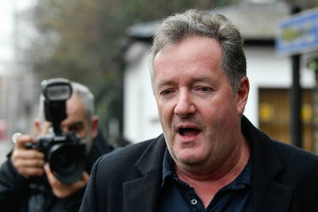 Piers Morgan walks with his daughter Elise in London