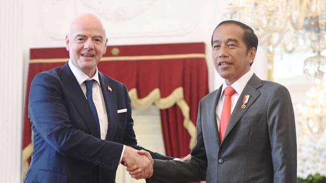 Indonesian President Joko Widodo shakes hands with FIFA’s president Gianni Infantino during their meeting at the Merdeka Palace in Jakarta