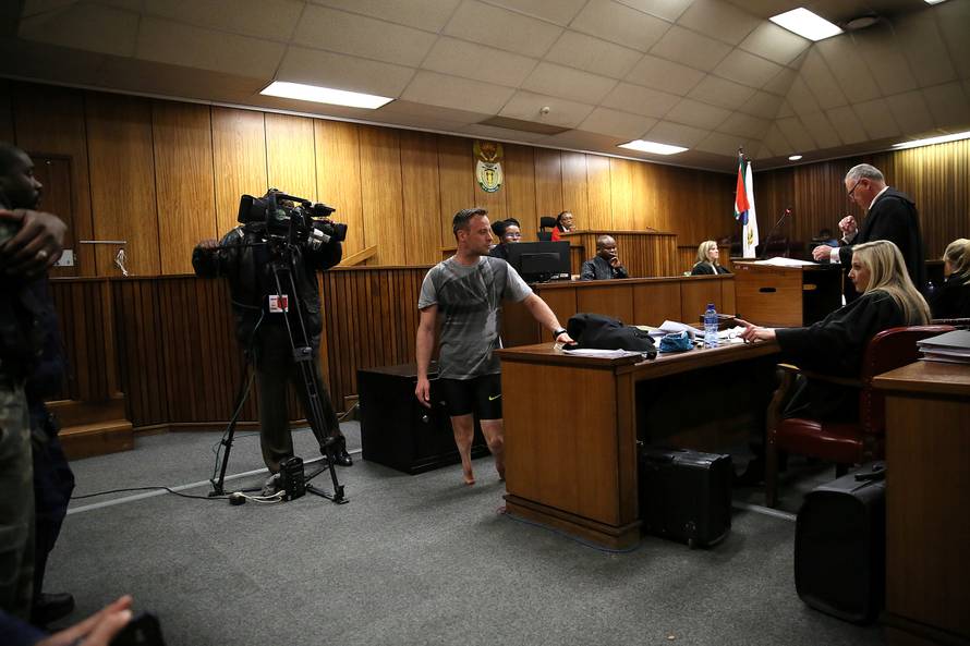 Paralympic gold medalist Oscar Pistorius walks across the courtroom without his prosthetic legs during the third day of his resentencing hearing for the 2013 murder of his girlfriend Reeva Steenkamp