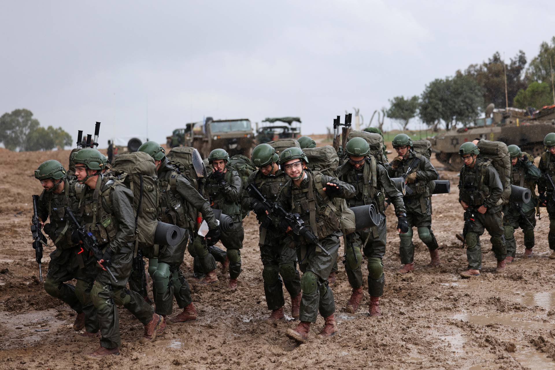 Israeli soldiers prepare to enter the Gaza Strip, amid the ongoing conflict between Israel and the Palestinian Islamist group Hamas, at Israel's border with Gaza in southern Israel