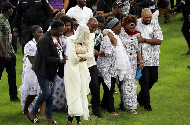 Family members of Ange Didier Houon, known as DJ Arafat, mourn during his funeral ceremony in Abidjan