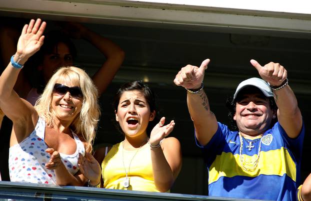 FILE PHOTO: Argentine soccer legend Maradona, his daughter Giannina and his ex-wife Villafane cheer for Boca Juniors in Buenos Aires