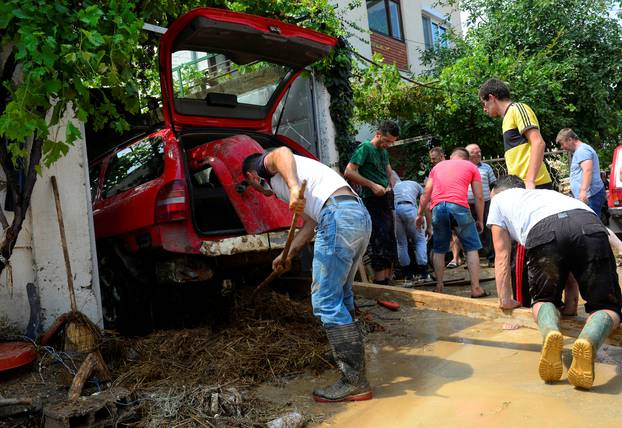 People clean up after heavy floods in Cento