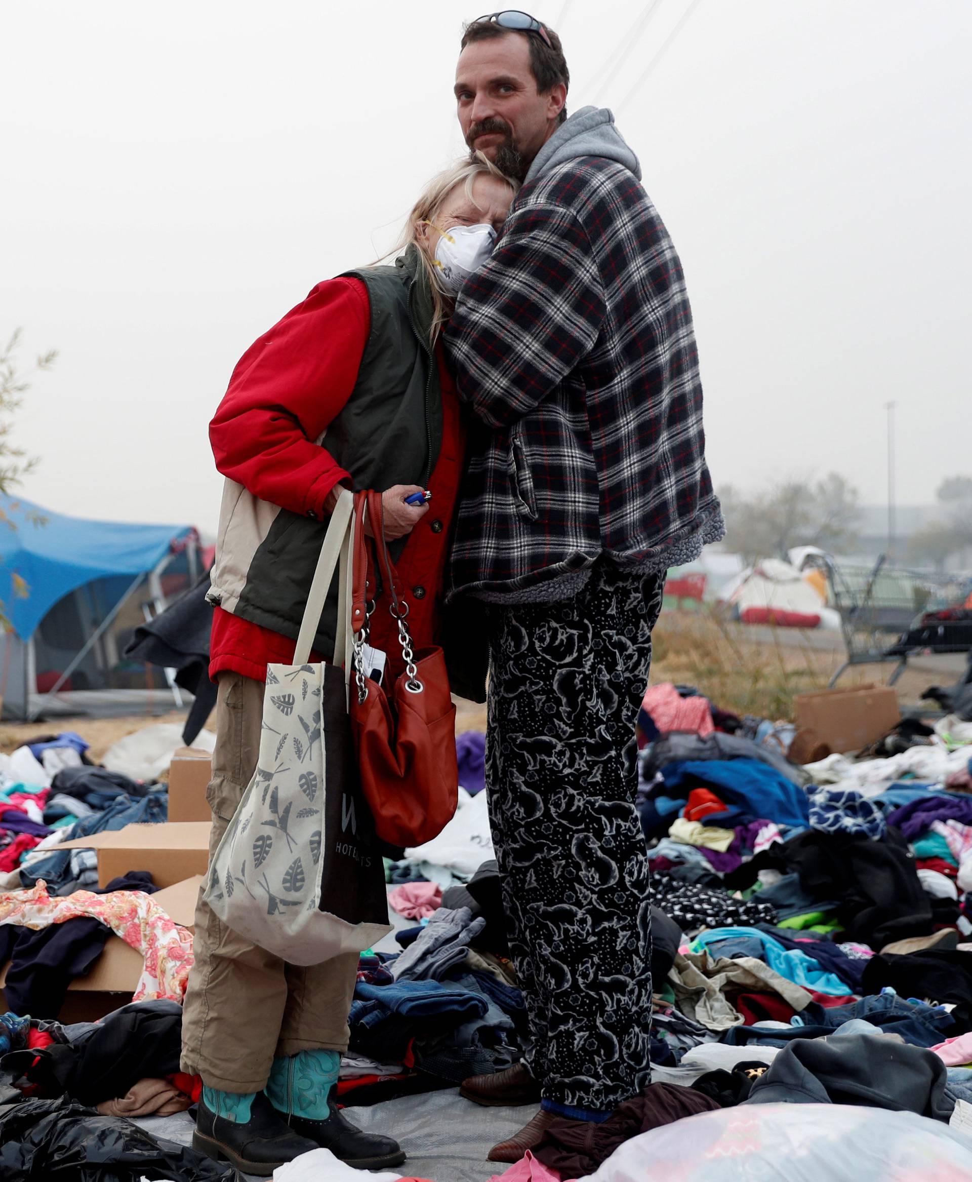Hogan comforts his mother while they stay at a makeshift evacuation center for people displaced by the Camp Fire in Chico