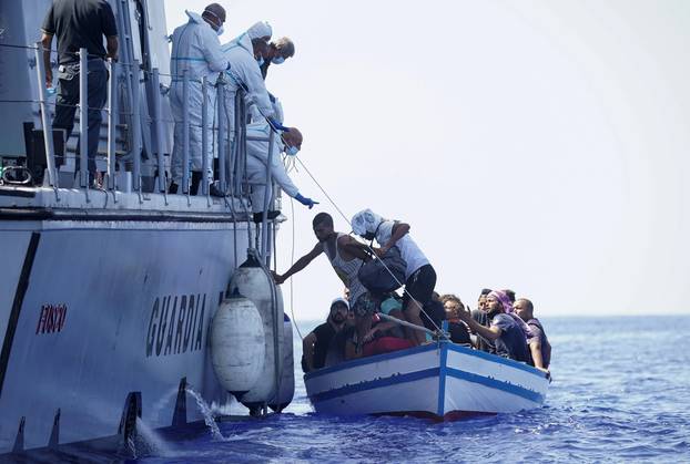 Migrants navigate to the Italian island of Lampedusa