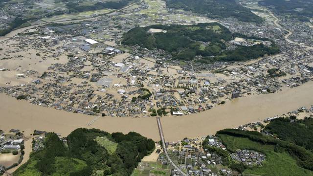 An aerial view shows flooded Kuma River caused by a heavy rain at a residential area in Hitoyoshi, Japan