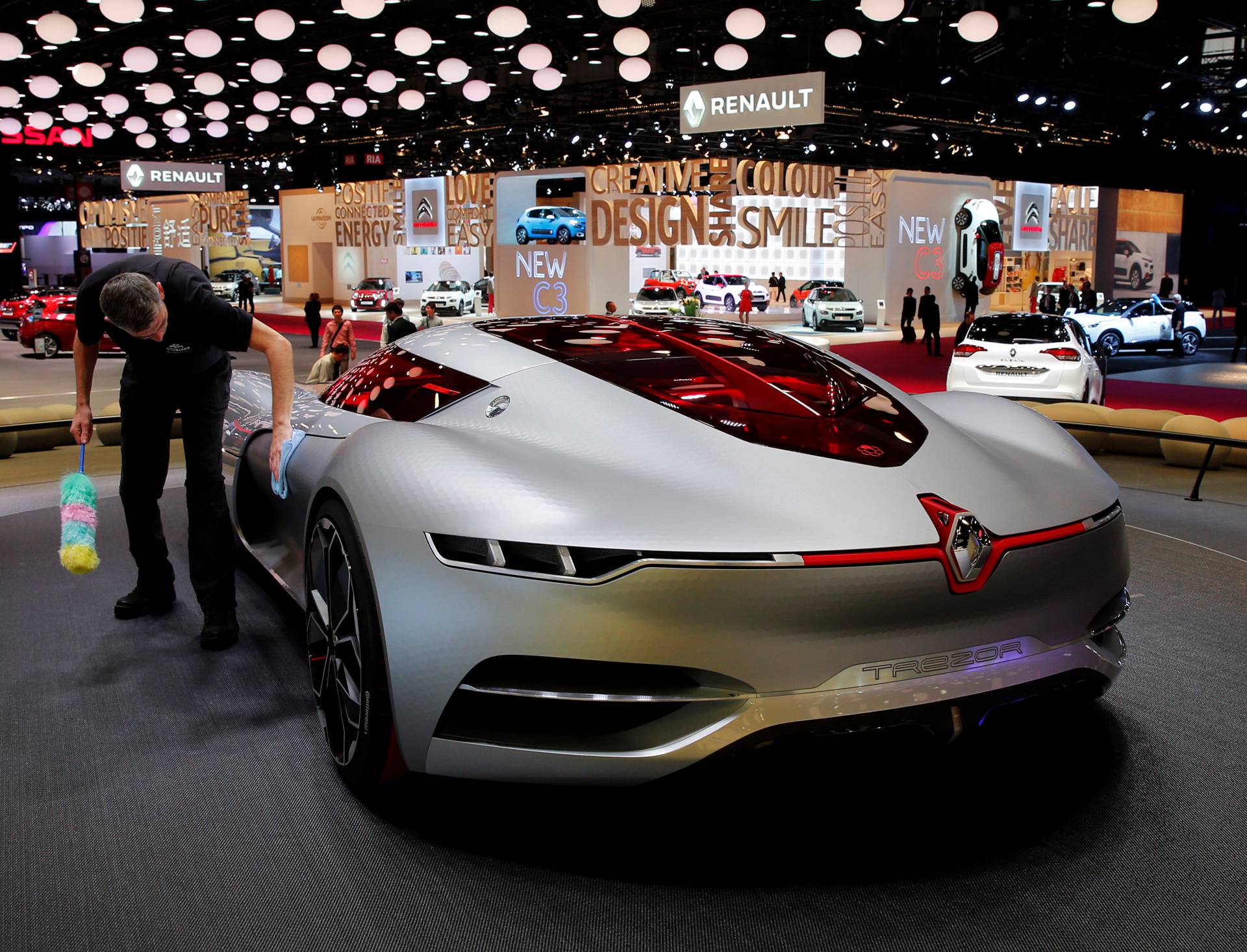 A man cleans the concept car Renault Trezor displayed on media day at the Paris auto show, in Paris