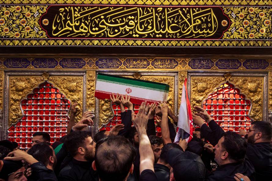 Mourners carry the coffins of family members of Iran’s late Supreme Leader Ayatollah Ali Khamenei, inside the shrine of Imam Abbas during funeral ceremonies in Karbala