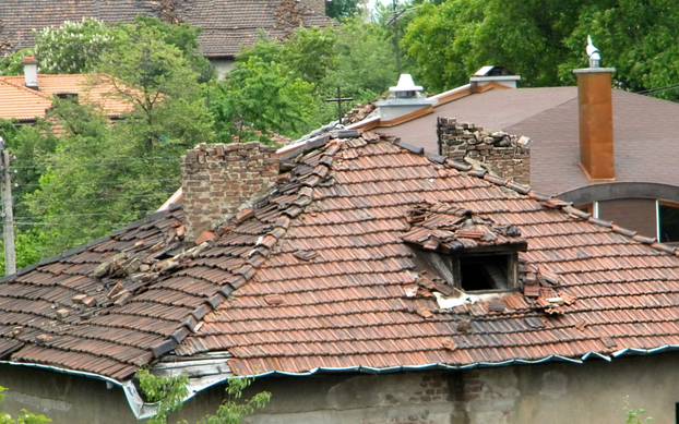 Damaged,Tile,Roof,Of,A,House,After,An,Earthquake