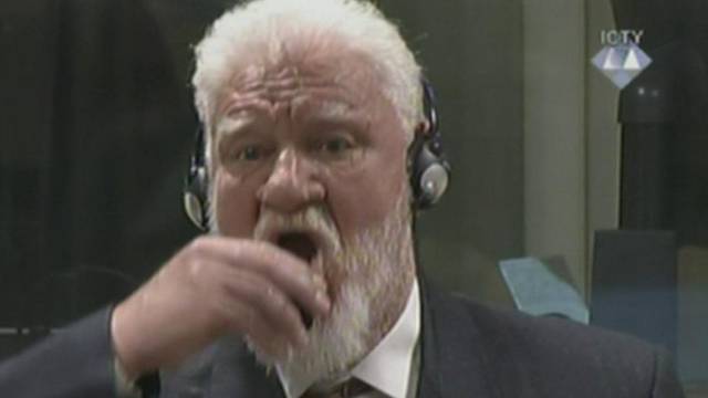 A wartime commander of Bosnian Croat forces, Slobodan Praljak, is seen during a hearing at the U.N. war crimes tribunal in the Hague