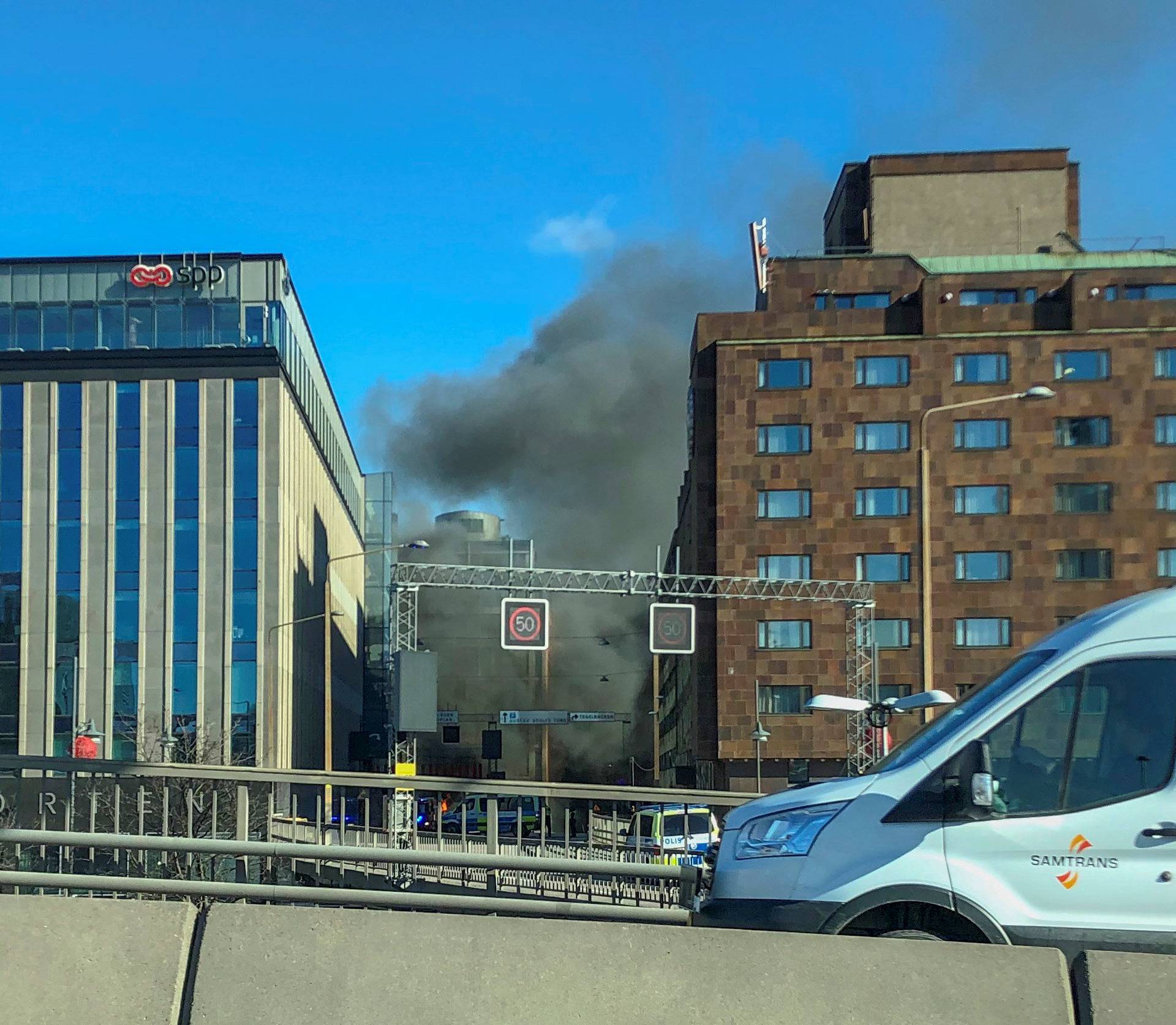 Smoke from a bus explosion and fire is seen in Tegelbacken in central Stockholm