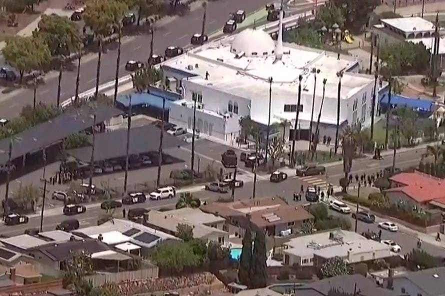 Police vehicles crowd nearby streets after an "active shooter situation" was reported at the Islamic Center in San Diego