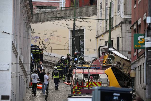 First responders work at the site of a funicular accident in Lisbon