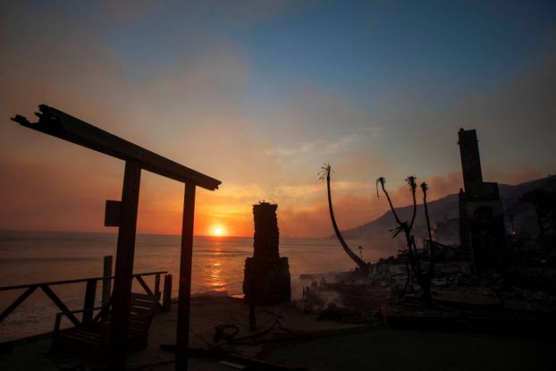 Palisades fire burns during a windstorm on the west side of Los Angeles