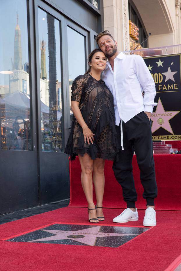 Eva Longoria and Ricky Martin pose on the Hollywood Walk of Fame in Los Angeles