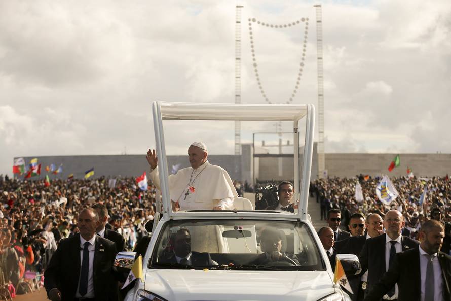 Pope Francis waves as he arrives at the Shrine of Our Lady of Fatima in Portugal