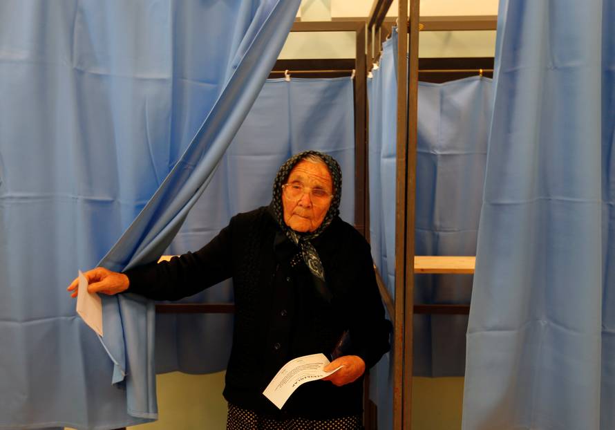 A Hungarian woman votes in a referendum on the European Union's migrant quotas in village of Roszke near the Serbian border