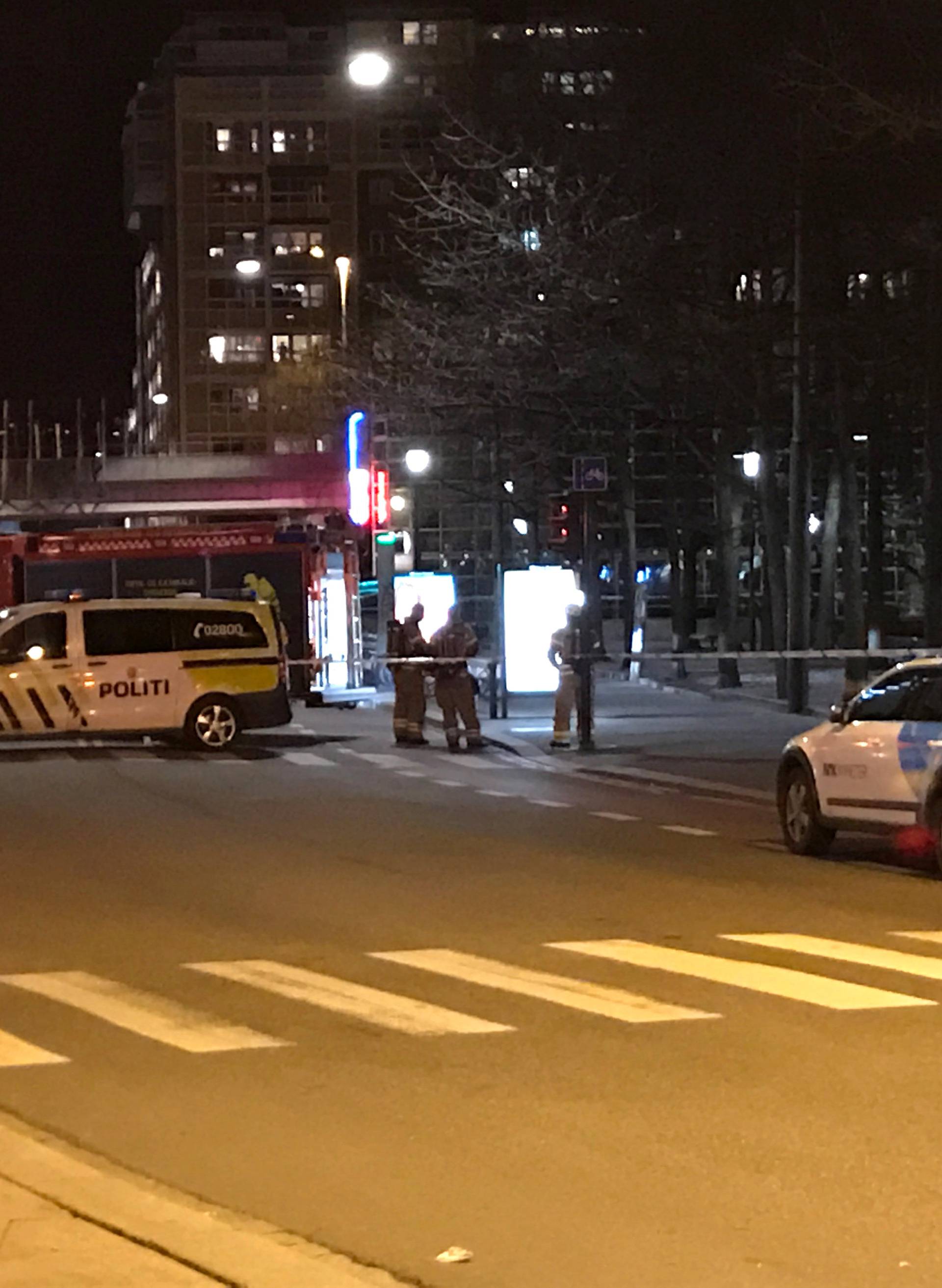 Rescue workers are seen in an area in central Oslo cordoned off by the police after the discovery of a "bomb-like device", in Oslo