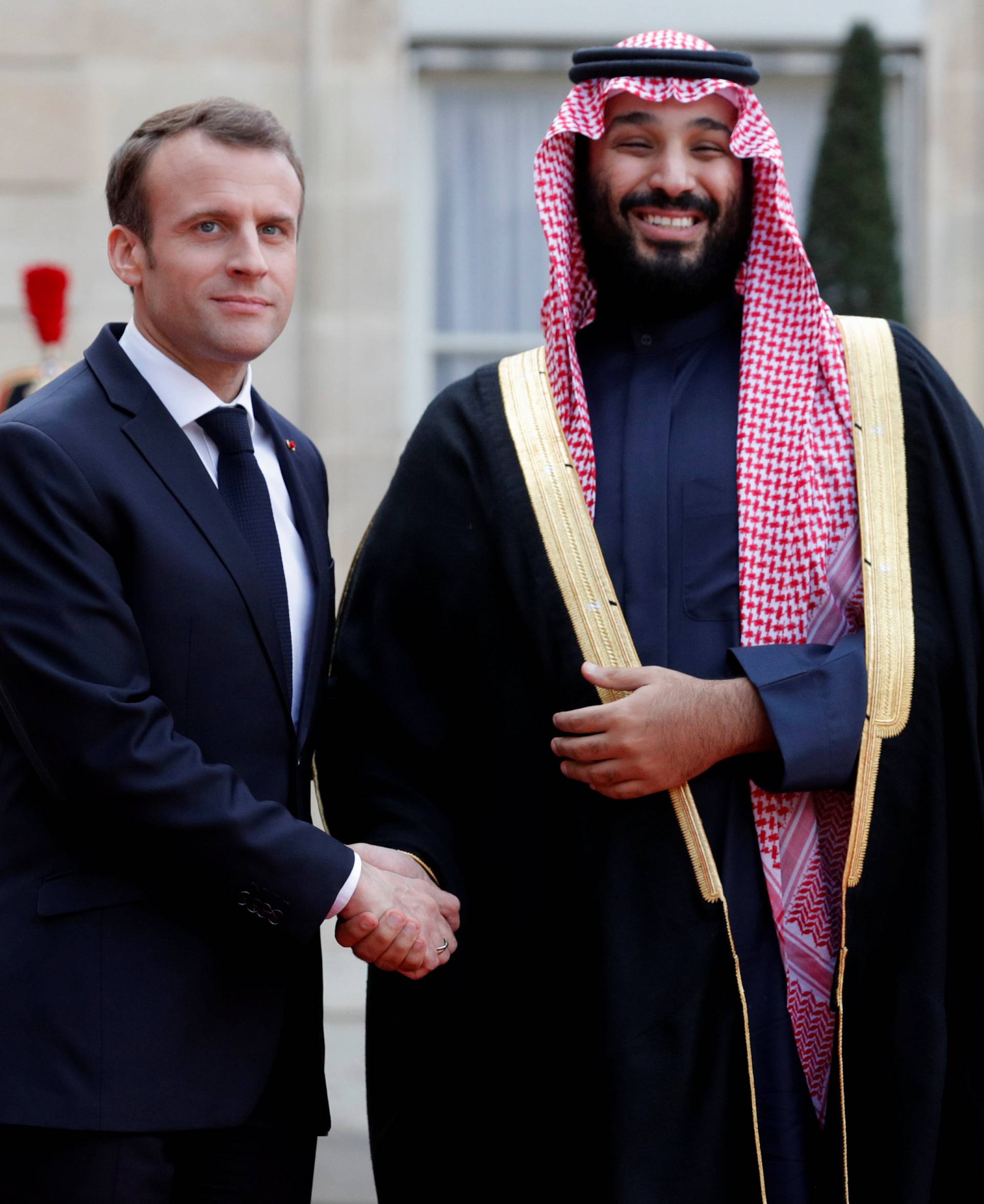 French President Emmanuel Macron welcomes Saudi Arabia's Crown Prince Mohammed bin Salman as he arrives at the Elysee Palace in Paris