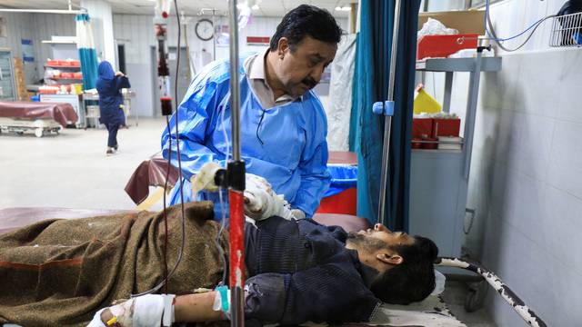 Police officer, who was injured after a bomb blast, receives first aid at hospital in Peshawar