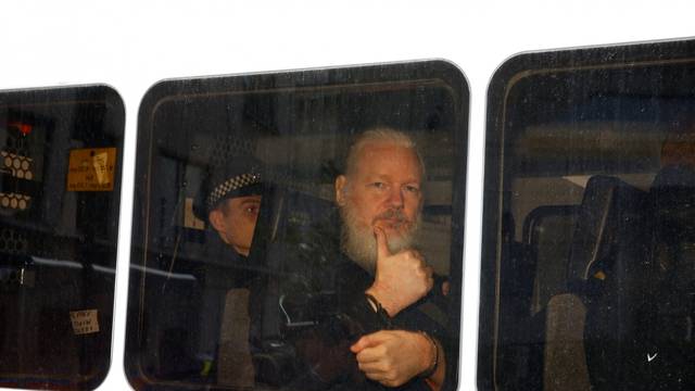 WikiLeaks founder Julian Assange is seen in a police van after was arrested by British police outside the Ecuadorian embassy in London