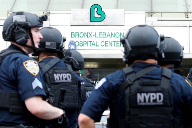NYPD officers wearing tactical gear work outside Bronx-Lebanon Hospital, after an incident in which a gunman fired shots inside the hospital in New York