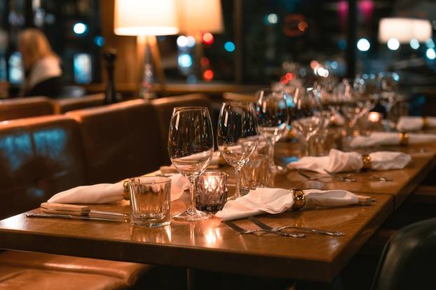 Retro,Restaurant,Long,Dining,Table,Setting,With,Silverware,And,Wineglass