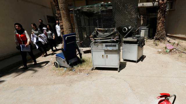 Burnt incubators stand outside a maternity ward after a fire broke out at Yarmouk hospital in Baghdad