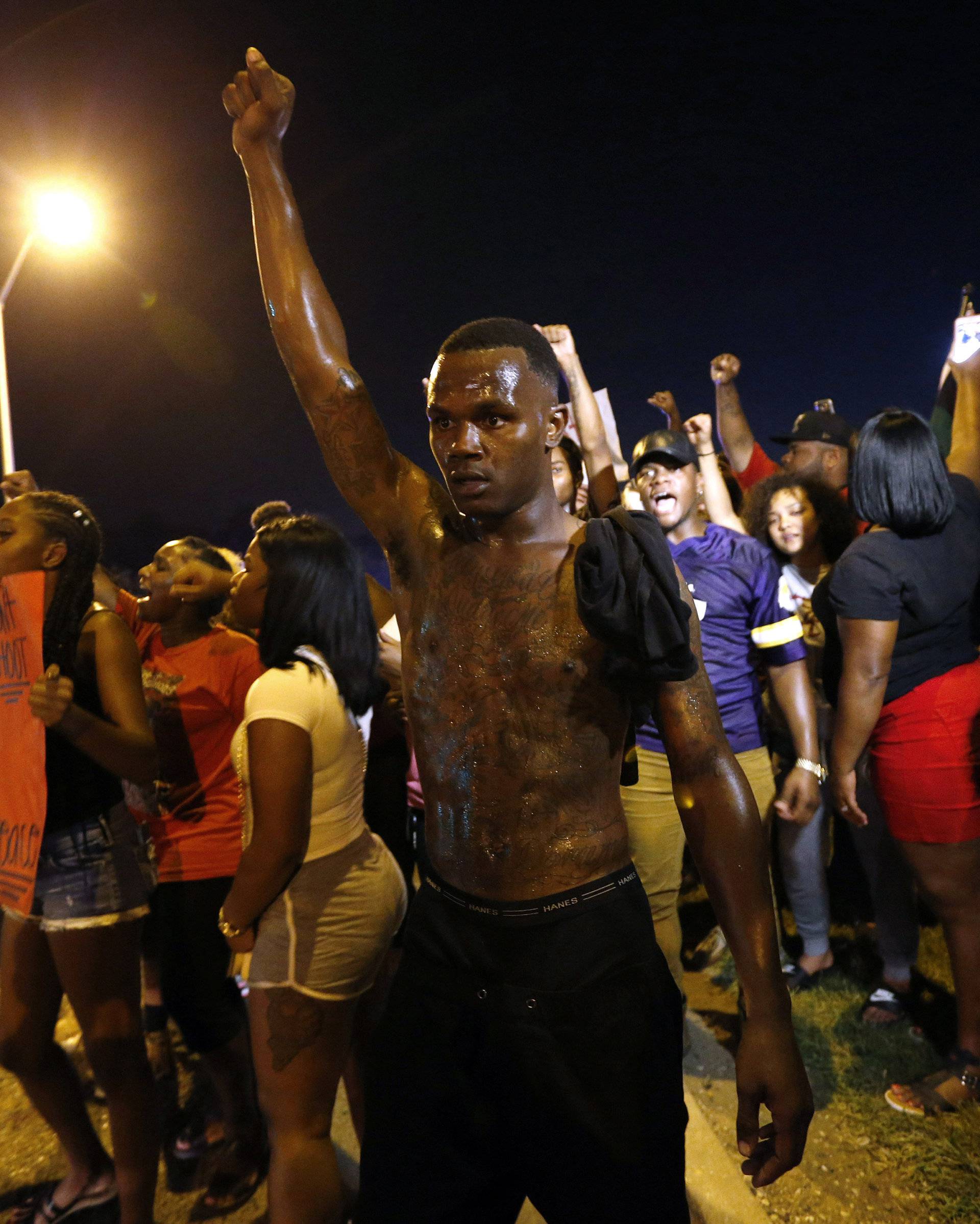 Demonstrators protest the shooting death of Alton Sterling near the headquarters of the Baton Rouge Police Department in Baton Rouge, Louisiana