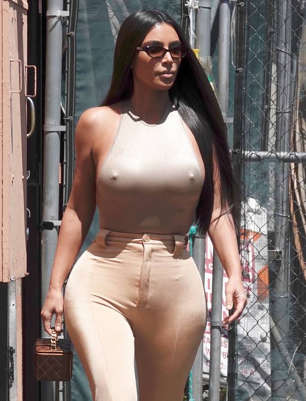 Kim Kardashian is seen leaving the back door of a restaurant in LA with her sister Khloe.