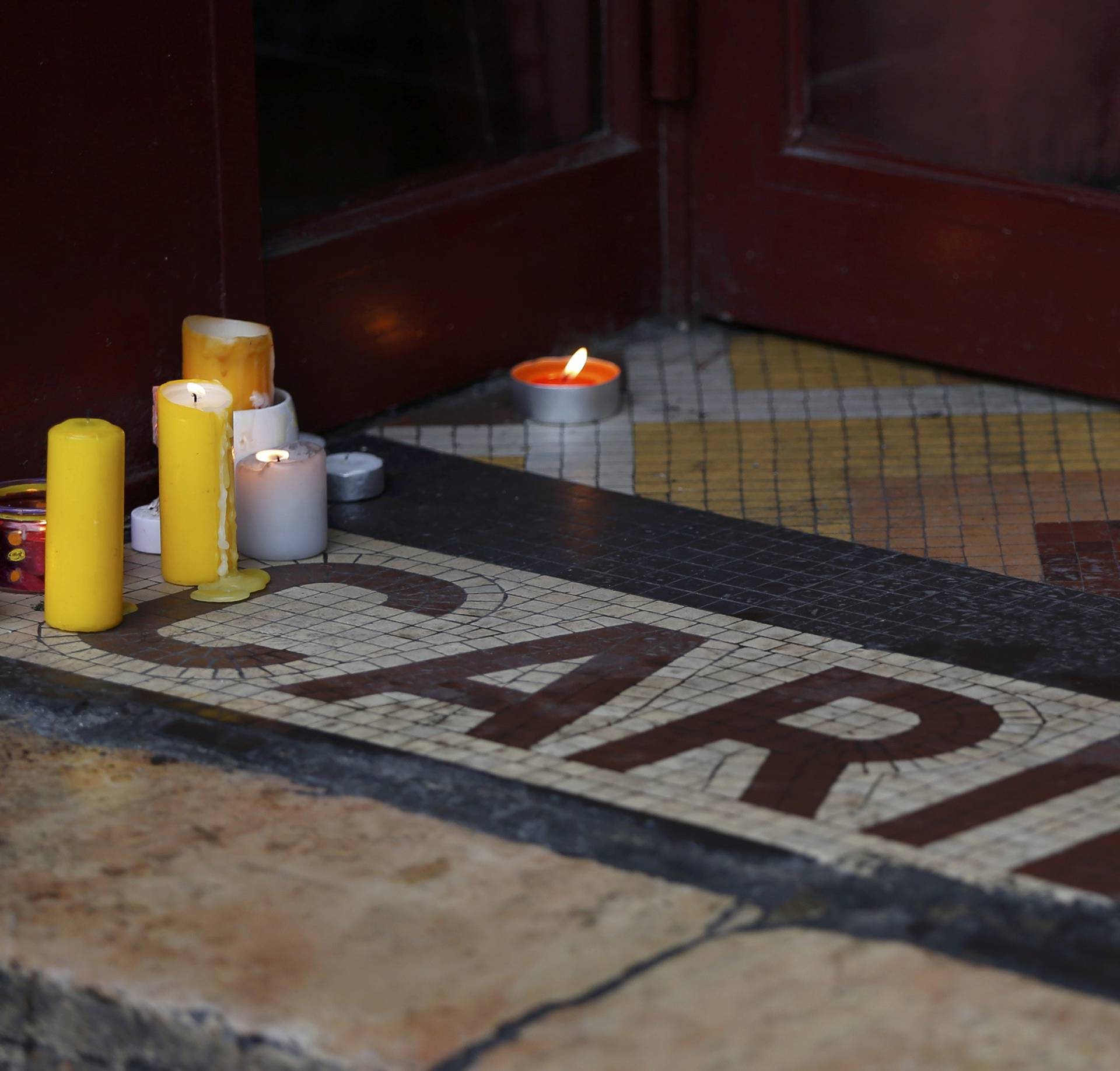 Candles are seen on the entrance of the "Le Carillon" bar and restaurant in Paris
