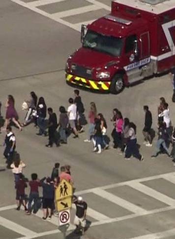 Students are evacuated from Marjory Stoneman Douglas High School during a shooting incident in Parkland