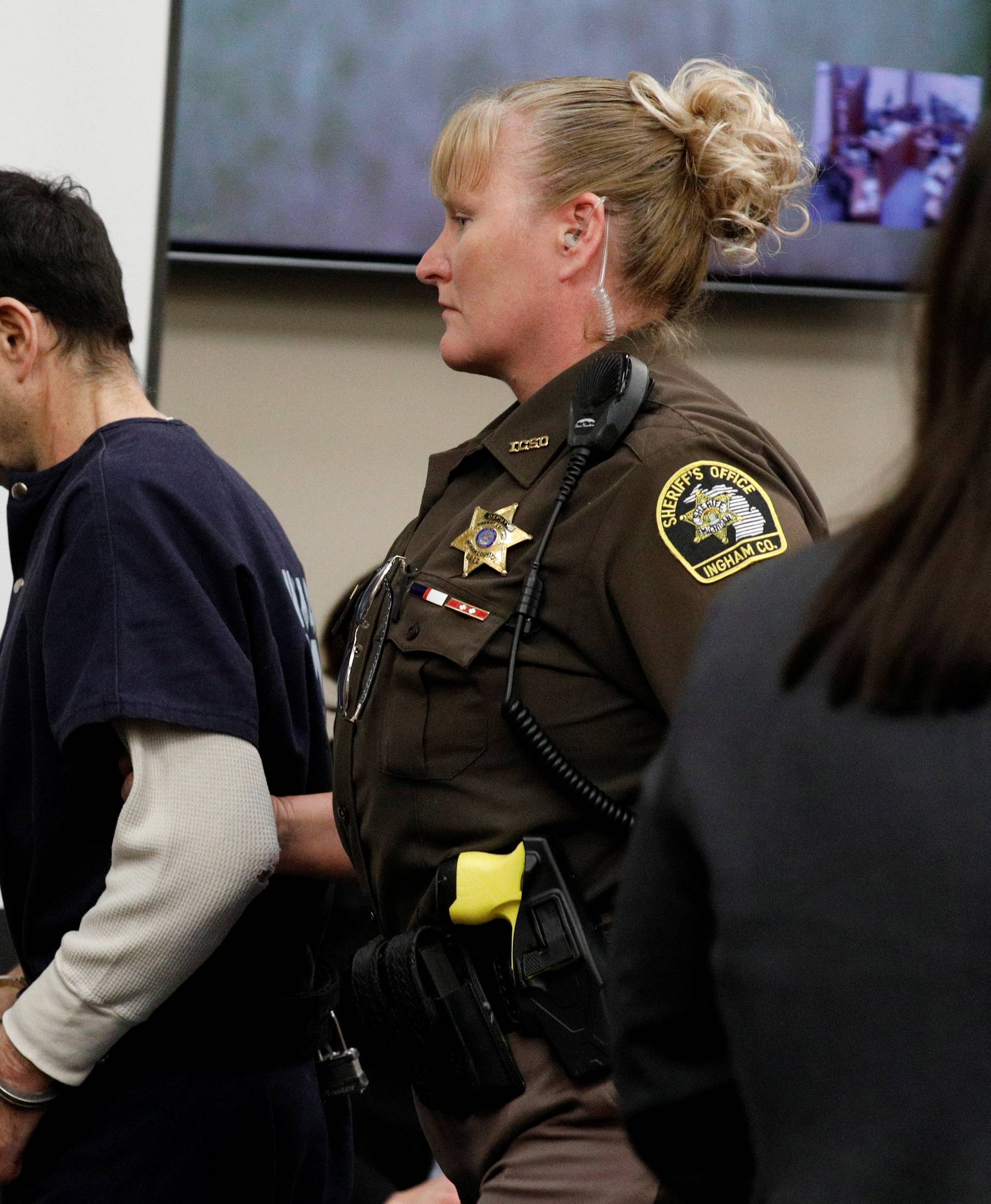 Larry Nassar, a former team USA Gymnastics doctor, who pleaded guilty in November 2017 to sexual assault charges, is escorted into the courtroom during his sentencing hearing in Lansing, Michigan
