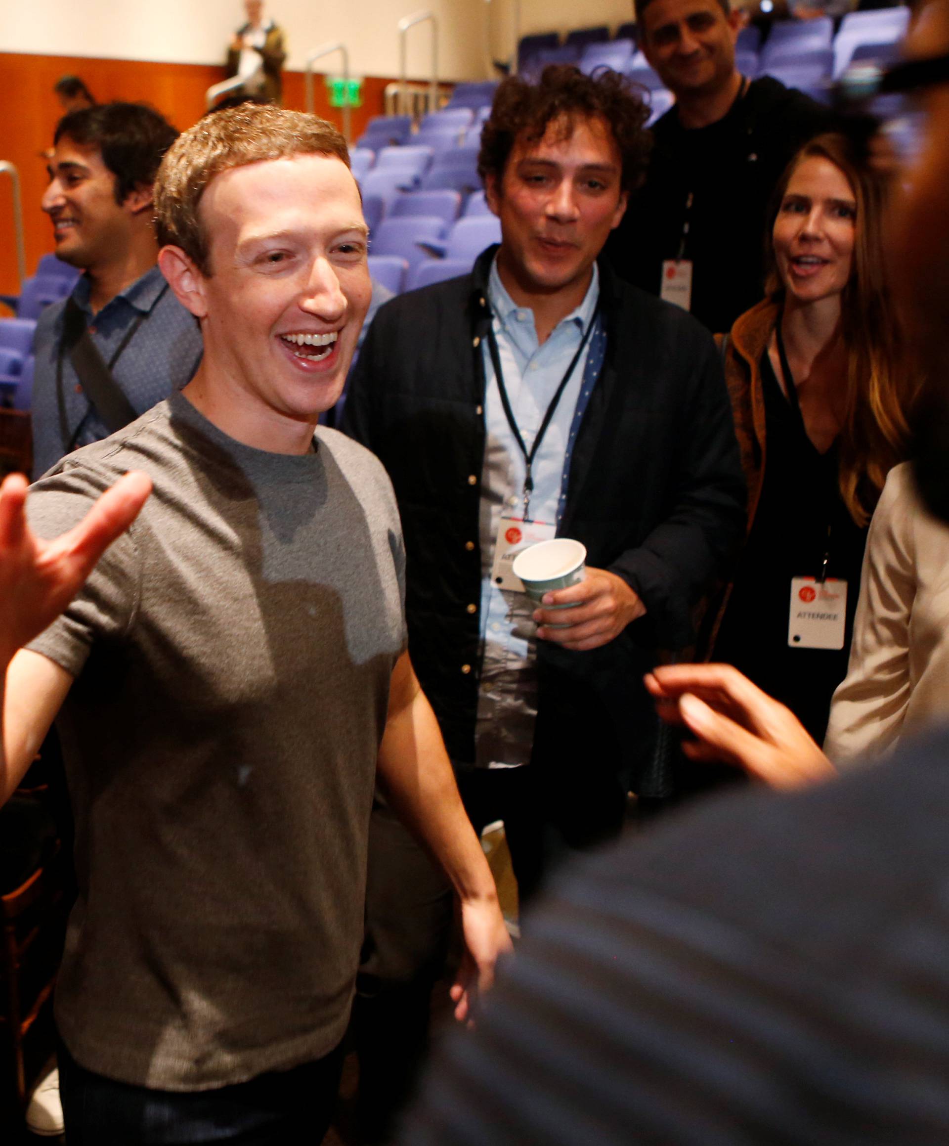 Mark Zuckerberg greets attendees after announcing the Chan Zuckerberg Initiative to cure all diseases by the end of the century during a news conference at UCSF Mission Bay in San Francisco, California
