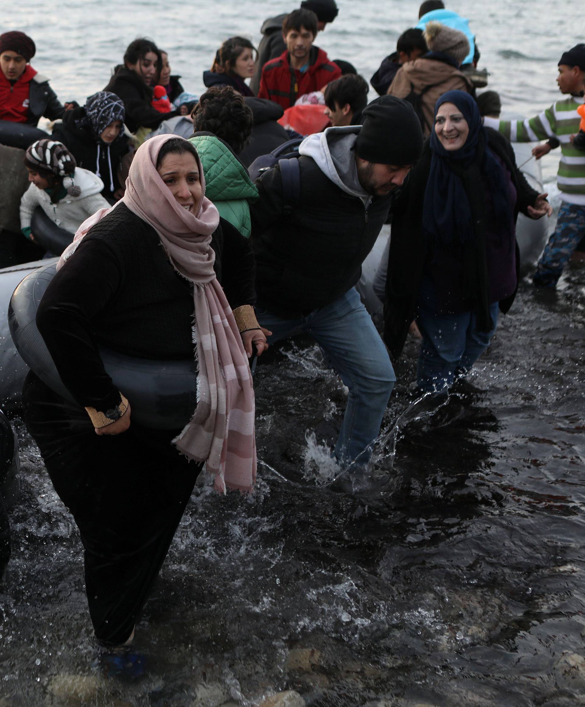 Migrants from Syria, Iraq, Afghanistan and Palestinian territories arrive on a dinghy near the city of Mytilene, after crossing part of the Aegean Sea from Turkey to the island of Lesbos