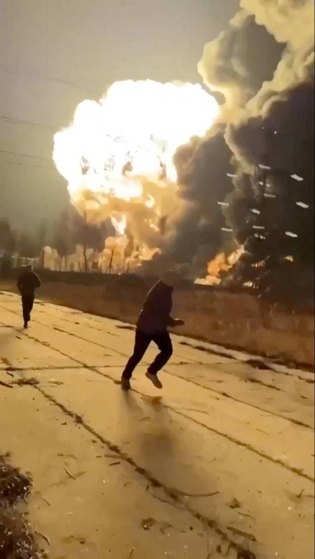 People run as smoke rises from an explosion during what the governor of Russia's Ryazan region southeast of Moscow describes as an air attack, in Ryazan
