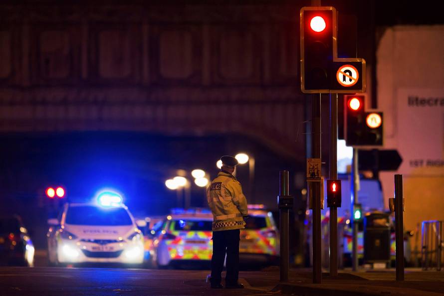 Police vehicles and a police officer are seen outside the Manchester Arena, where U.S. singer Ariana Grande had been performing in Manchester, northern England, Britain