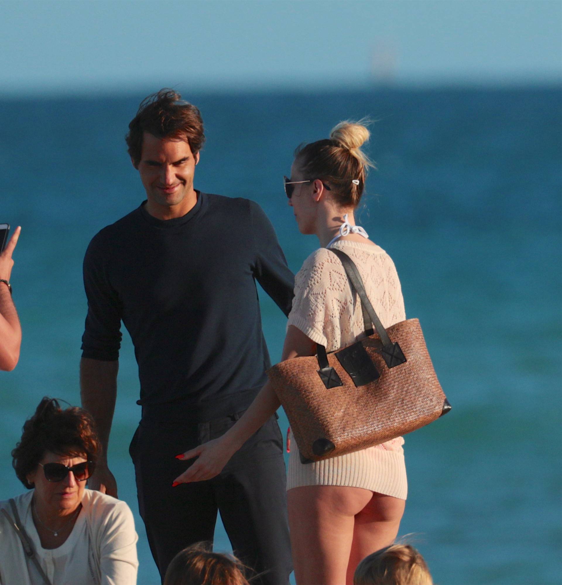 Roger Federer takes selfies with scantily clad woman