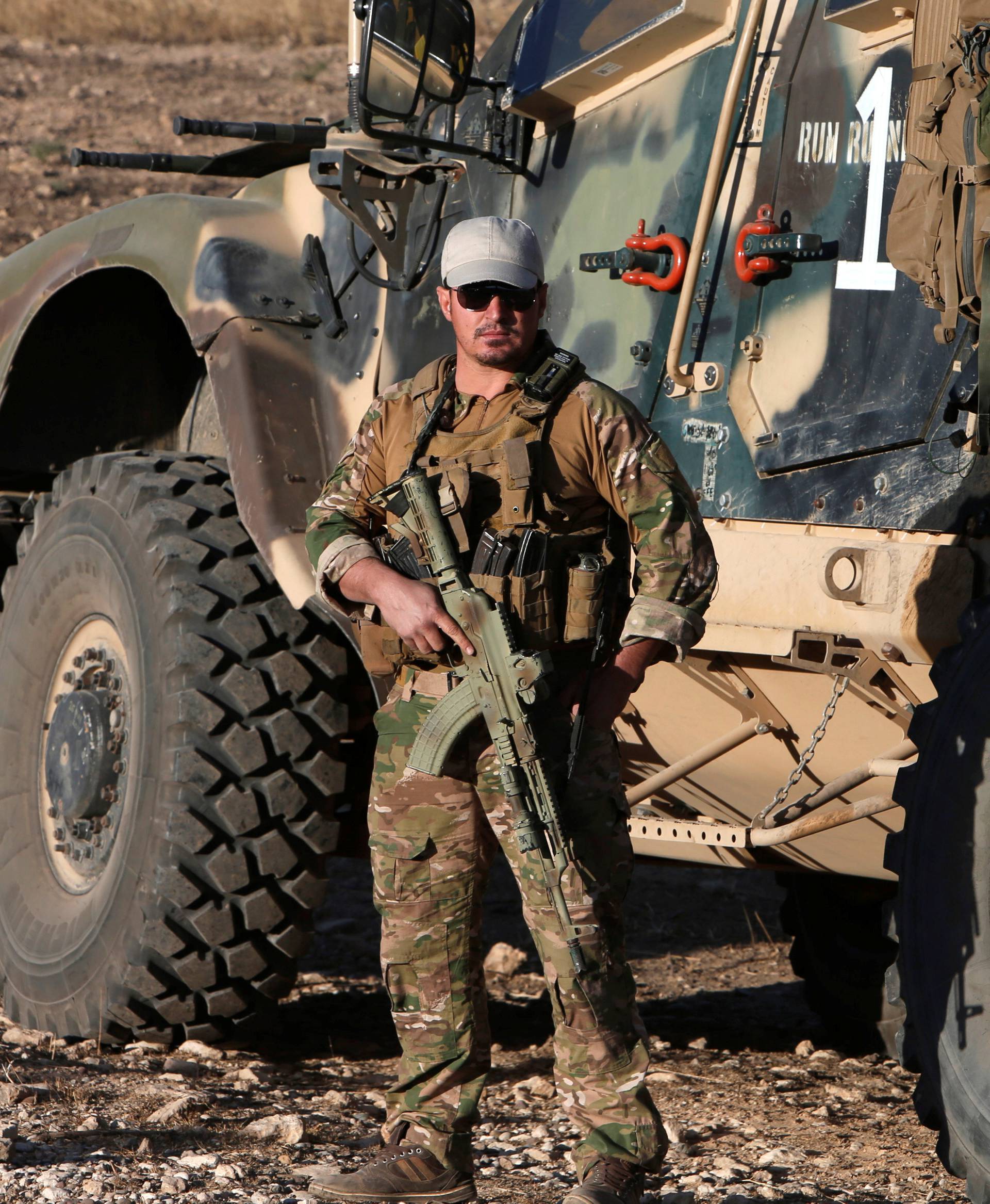 A member from western forces stands with his weapon in the east of Mosul