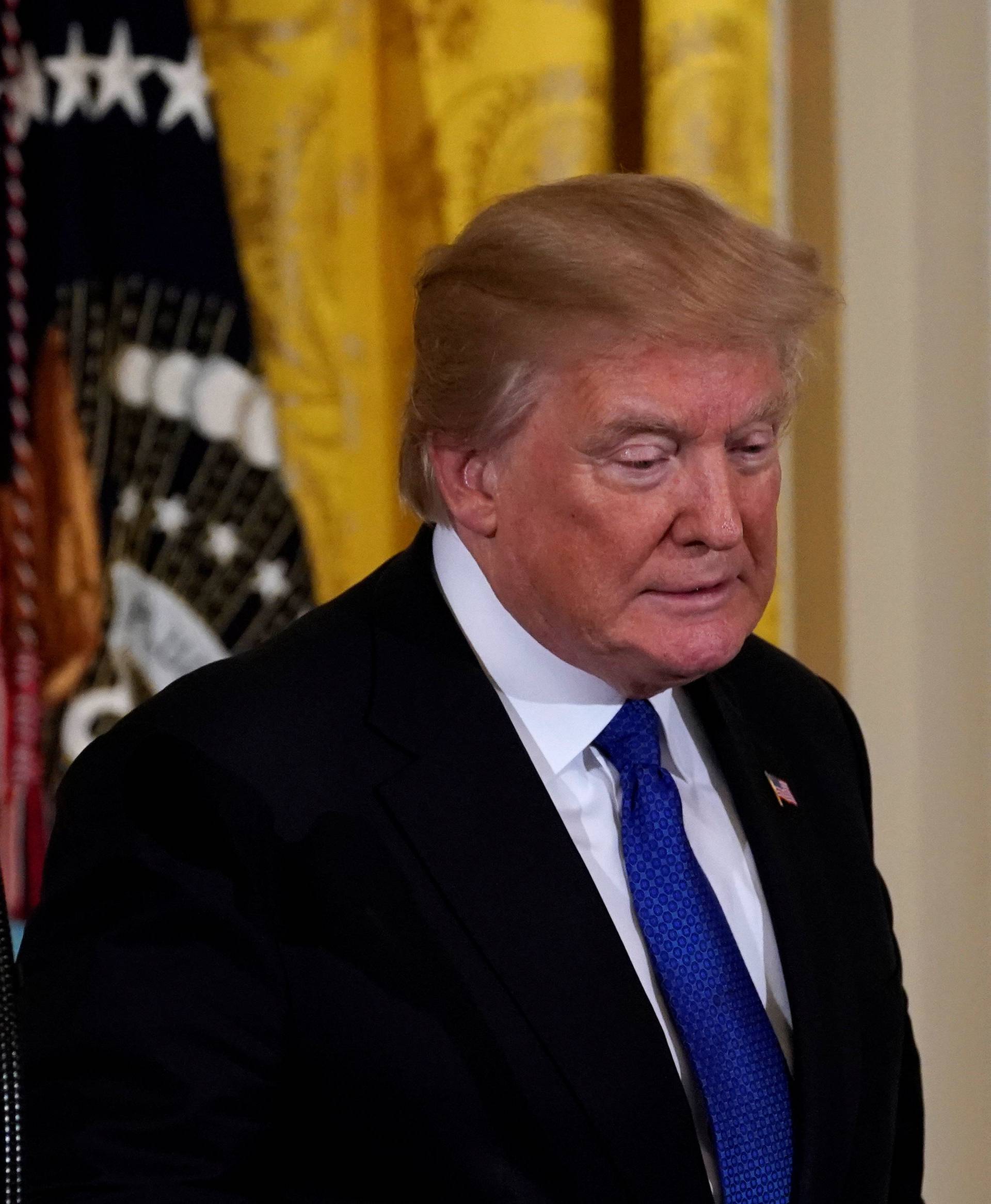 President Donald Trump leaves after delivering remarks at a working session with mayors