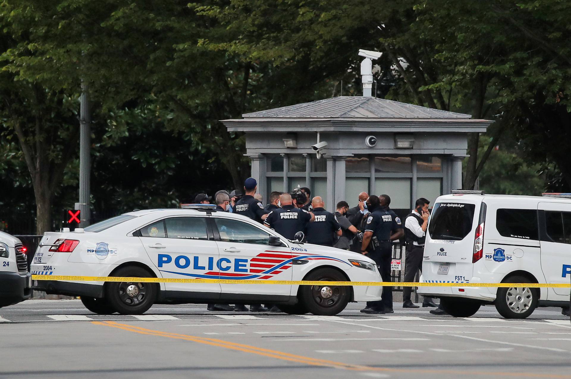 Police officers stand guard after a shooting incident outside the White House, in Washington