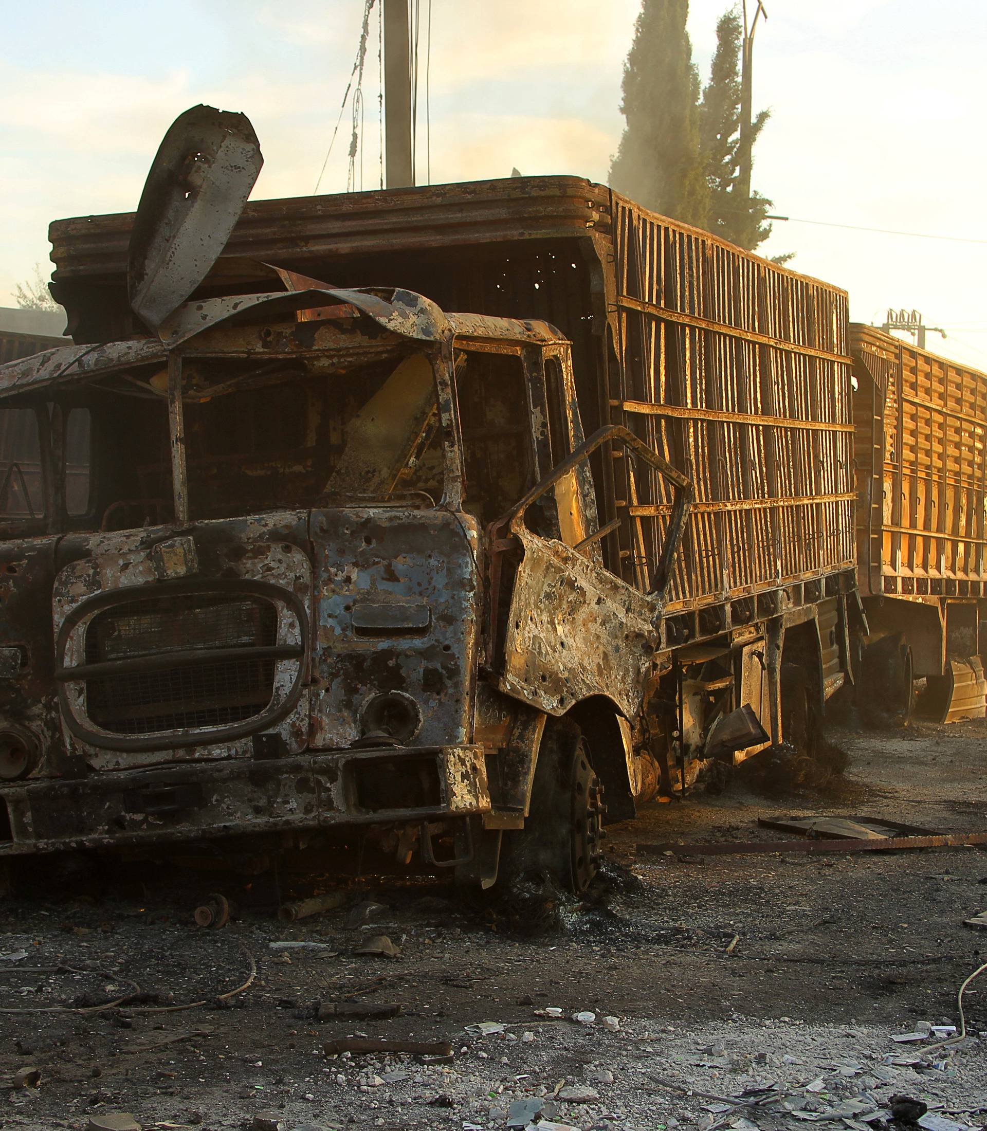 Damaged aid trucks are pictured after an airstrike on the rebel held Urm al-Kubra town